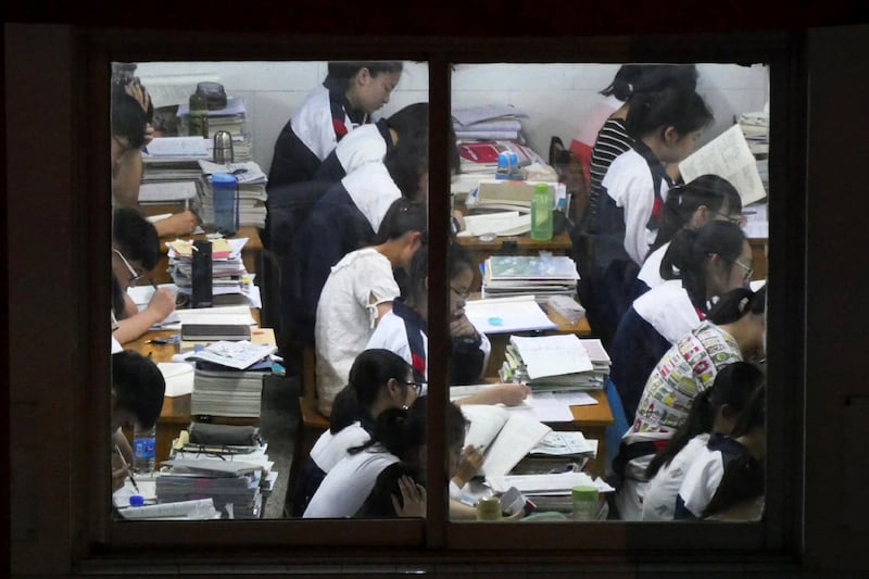 Students study in their classrooms at night at a school in China's eastern Jiangsu province on May 31, 2017.