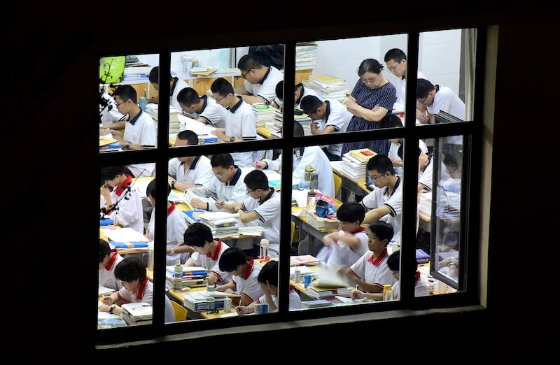 This photo taken on May 17, 2023, shows high school students going through exam papers, ahead of the National College Entrance Examination in China's northern Hebei province.
