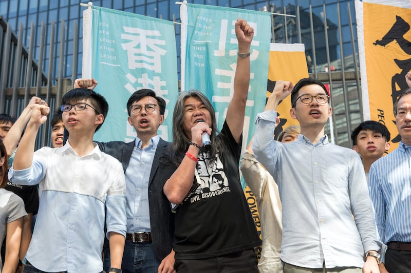 From left to right: protest leader Joshua Wong, Hong Kong pro-democracy party League of Social Democrats (LSD) chairman Avery Ng, pro-democracy lawmaker Leung Kwok-hung, also known as "Long Hair", and pro-democracy lawmaker Nathan Law hold a protest against their recent arrests in Hong Kong on June 30, 2017.