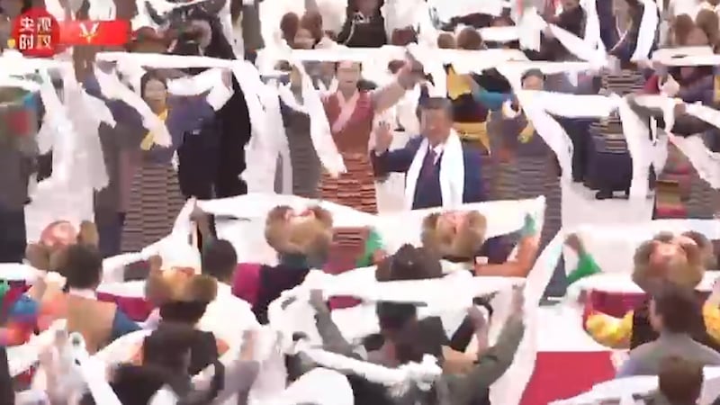 In this image made from Chinese government video, Chinese President Xi Jinping, center, waves as he is greeted upon his arrival in Lhasa, Tibet Autonomous Region, Aug. 20, 2025.